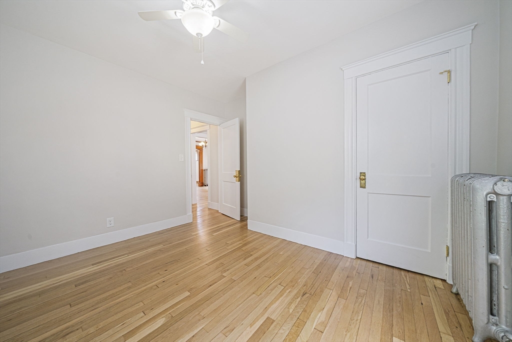 104 Greaton Road, Unit 1 Boston, MA 02132 - Photo 19 of 29 a view of an empty room with wooden floor