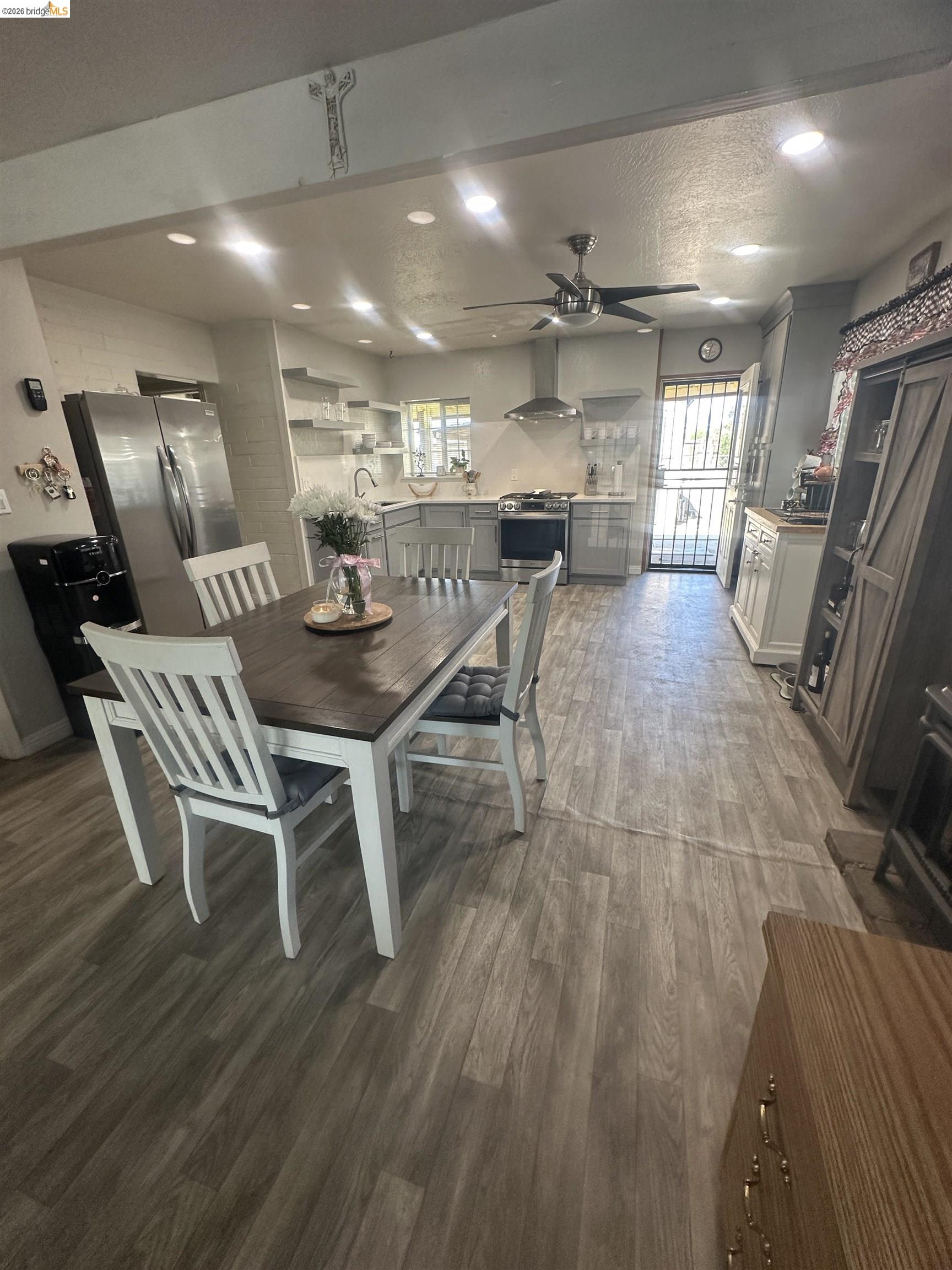 2831 Fabian Road Tracy, CA 95377 - Photo 9 of 23 Recessed lighting, wood-finish flooring, ceiling fan, stainless steel appliances, and a range hood