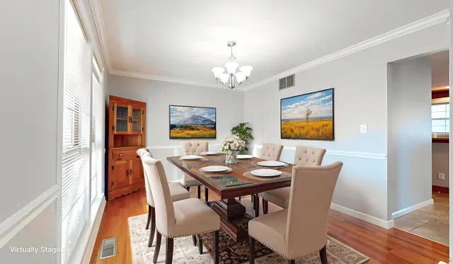 a view of a dining room with furniture and wooden floor