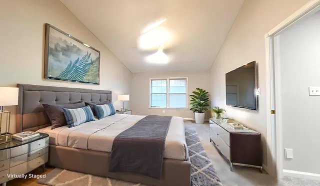 a bedroom with bed and glass door