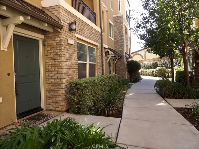 a view of a pathway both side of the house