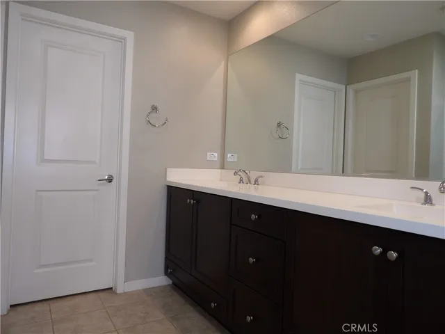 a bathroom with a double vanity sink and mirror