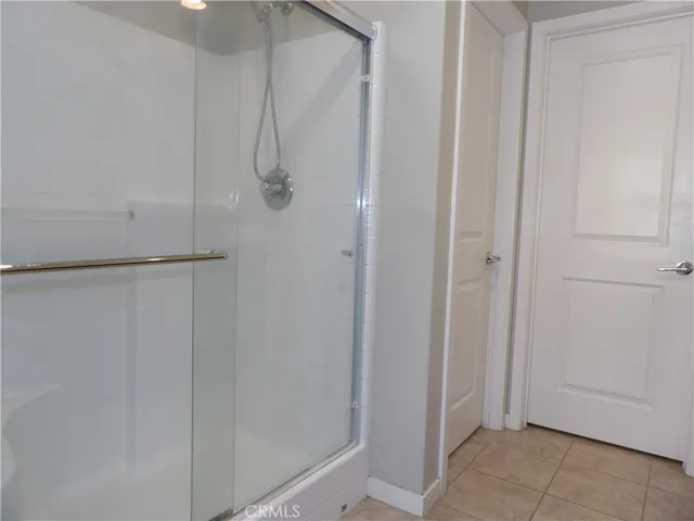 a bathroom with a glass shower door