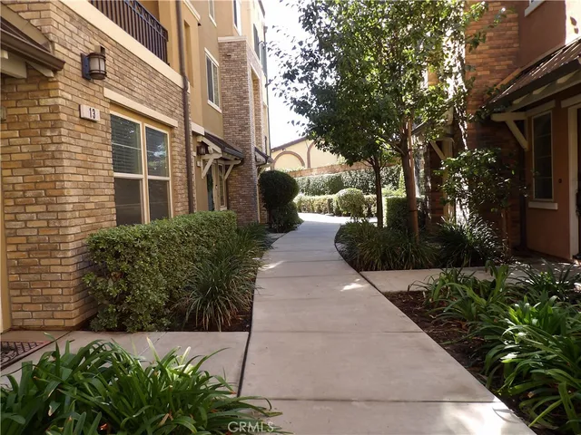 a view of a pathway both side of the house