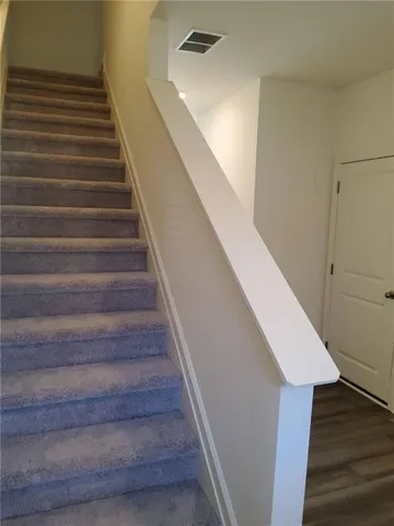 a view of a hallway to rooms