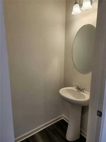 a bathroom with a sink toilet and a mirror