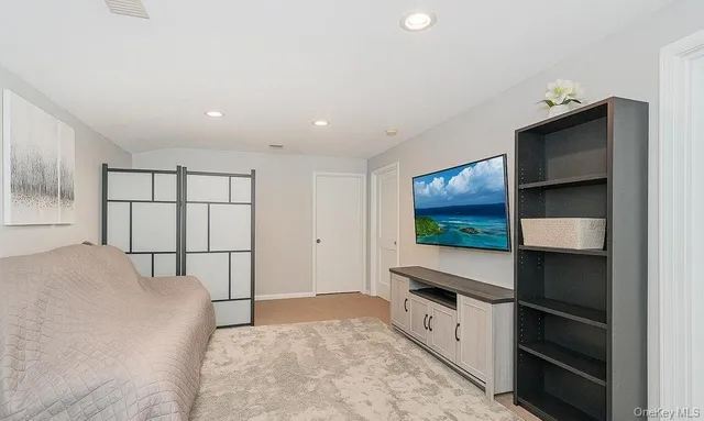 a bedroom with furniture and flat screen tv