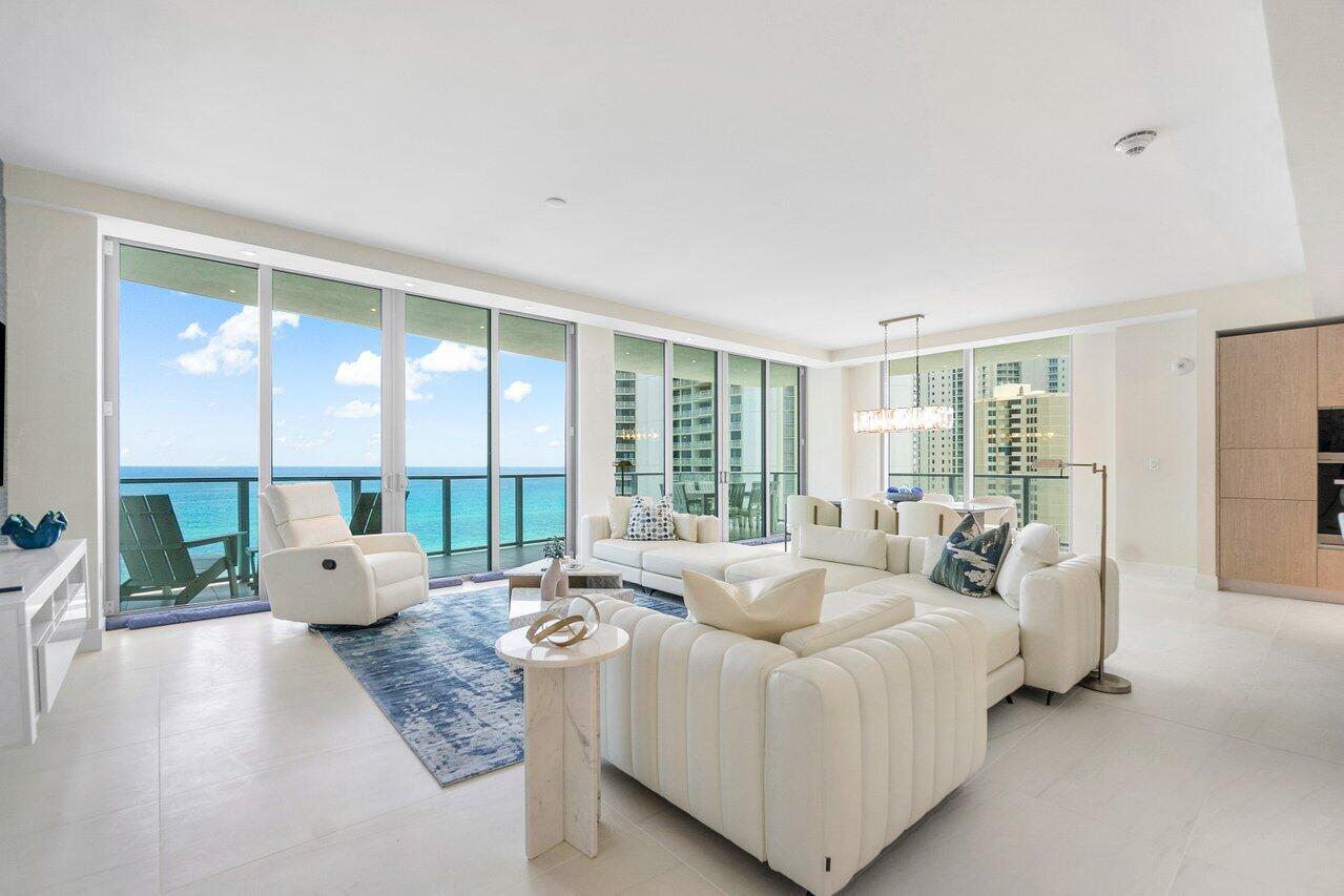3100 North Ocean Drive, Unit 1505 Riviera Beach, FL 33404 - Photo 13 of 60 a living room with furniture and large windows