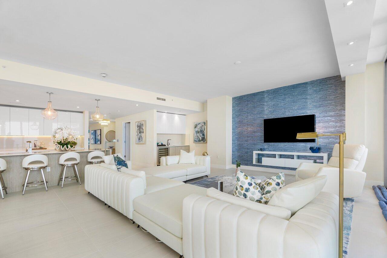 3100 North Ocean Drive, Unit 1505 Riviera Beach, FL 33404 - Photo 16 of 60 a living room with furniture and a flat screen tv