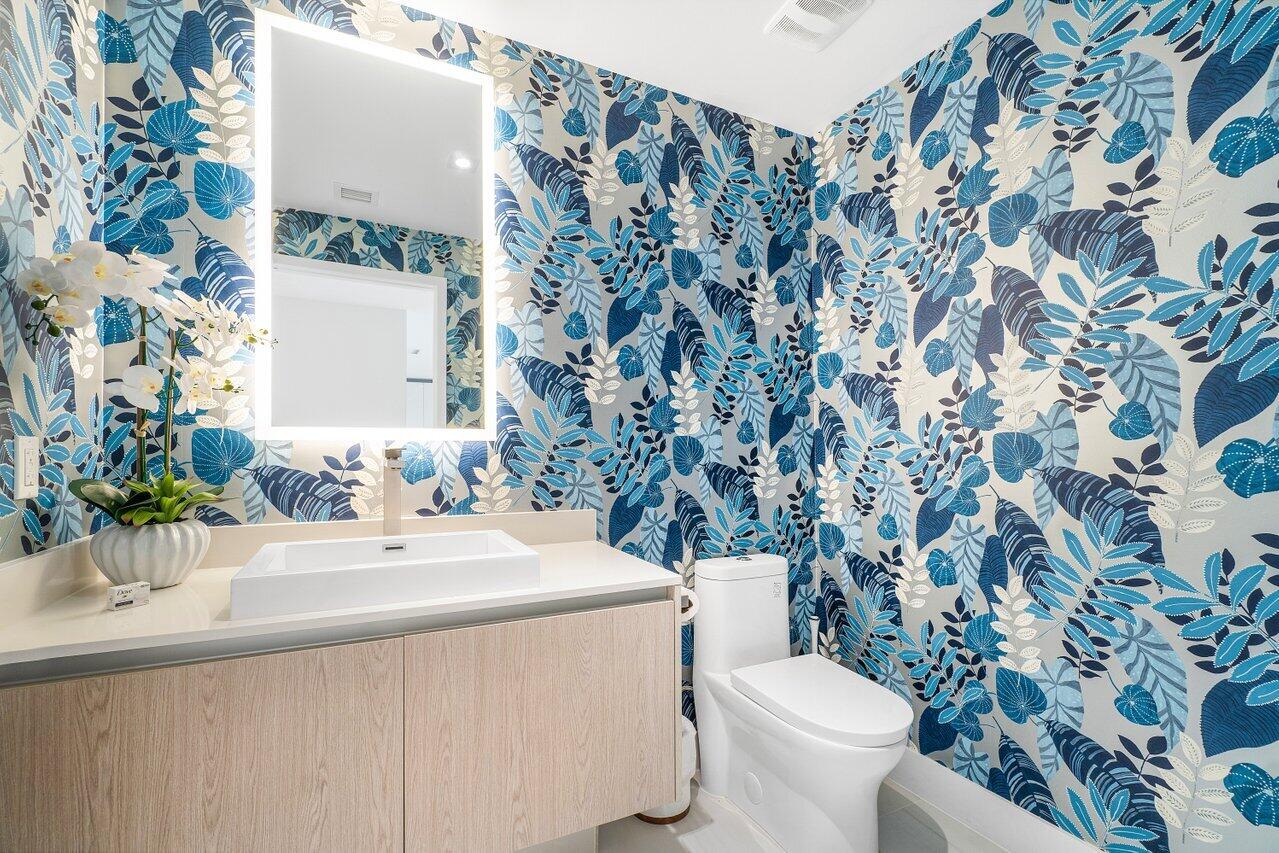3100 North Ocean Drive, Unit 1505 Riviera Beach, FL 33404 - Photo 17 of 60 a bathroom with a sink and mirror with toilet