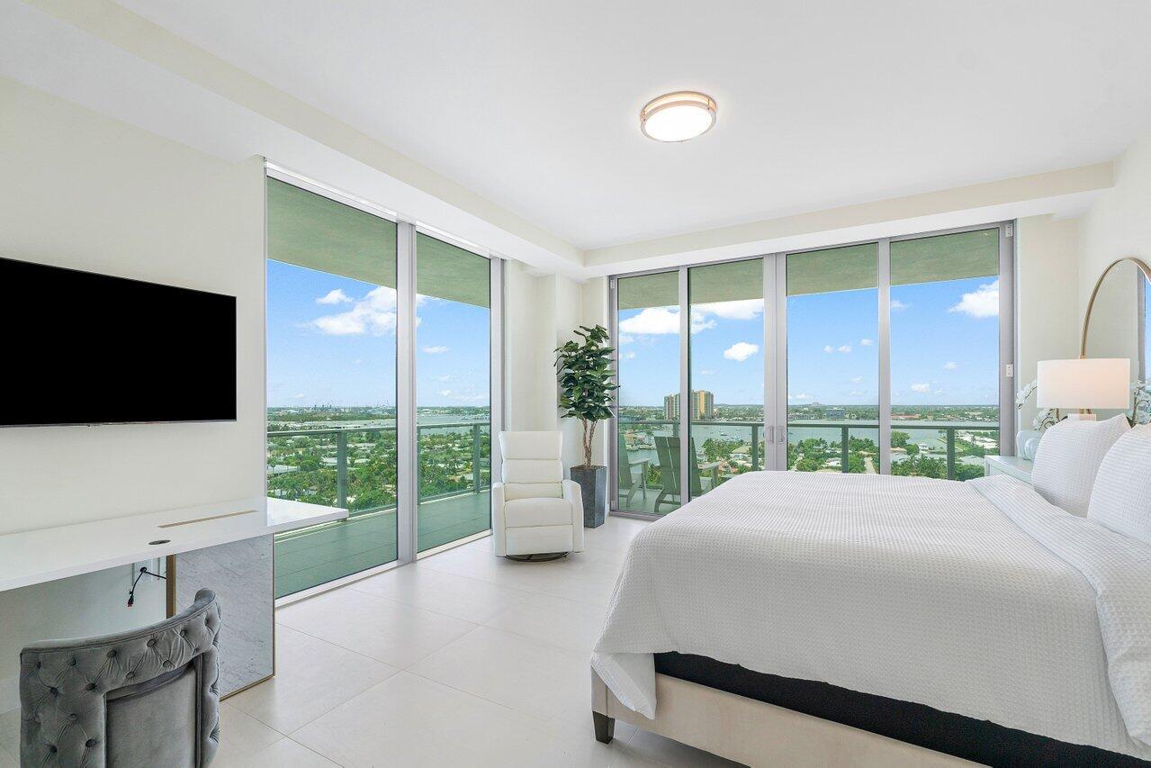 3100 North Ocean Drive, Unit 1505 Riviera Beach, FL 33404 - Photo 19 of 60 a bedroom with a large window and a flat screen tv