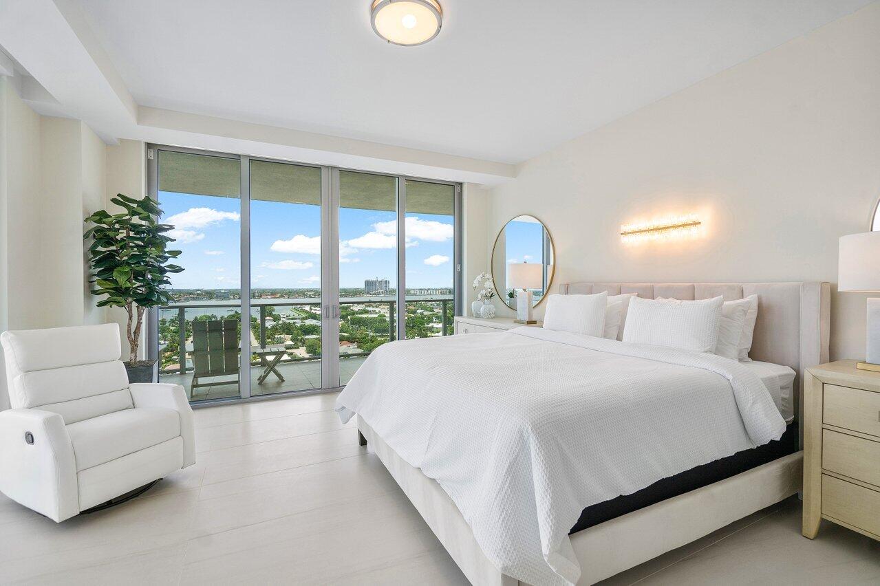 3100 North Ocean Drive, Unit 1505 Riviera Beach, FL 33404 - Photo 20 of 60 a bedroom with a large bed and a large window