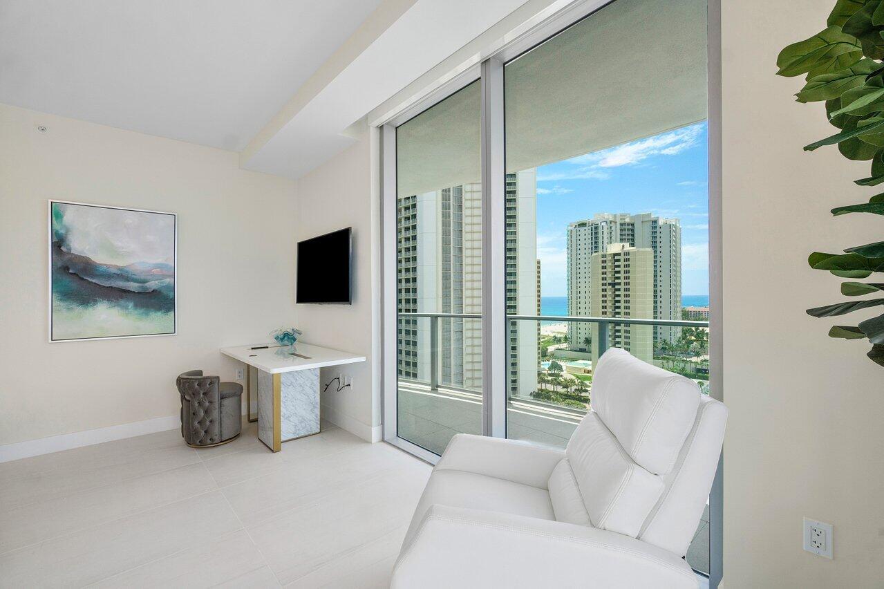 3100 North Ocean Drive, Unit 1505 Riviera Beach, FL 33404 - Photo 21 of 60 a living room with furniture and a flat screen tv