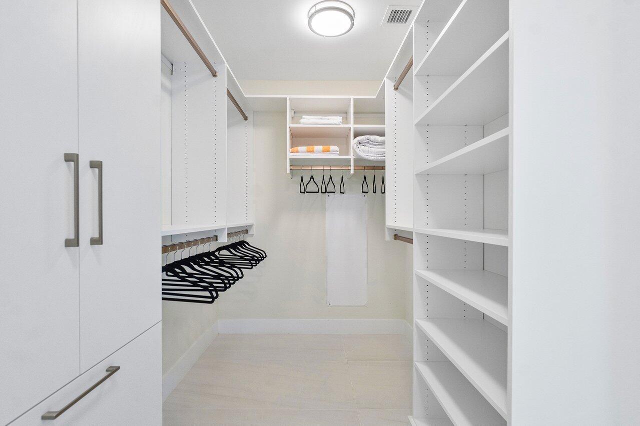 3100 North Ocean Drive, Unit 1505 Riviera Beach, FL 33404 - Photo 22 of 60 a view of walk in closet with clothes and shoes