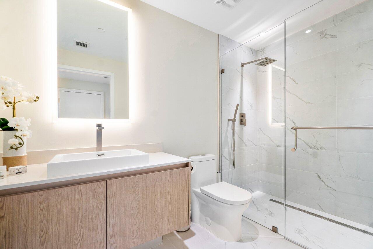 3100 North Ocean Drive, Unit 1505 Riviera Beach, FL 33404 - Photo 27 of 60 a bathroom with a sink a toilet and shower