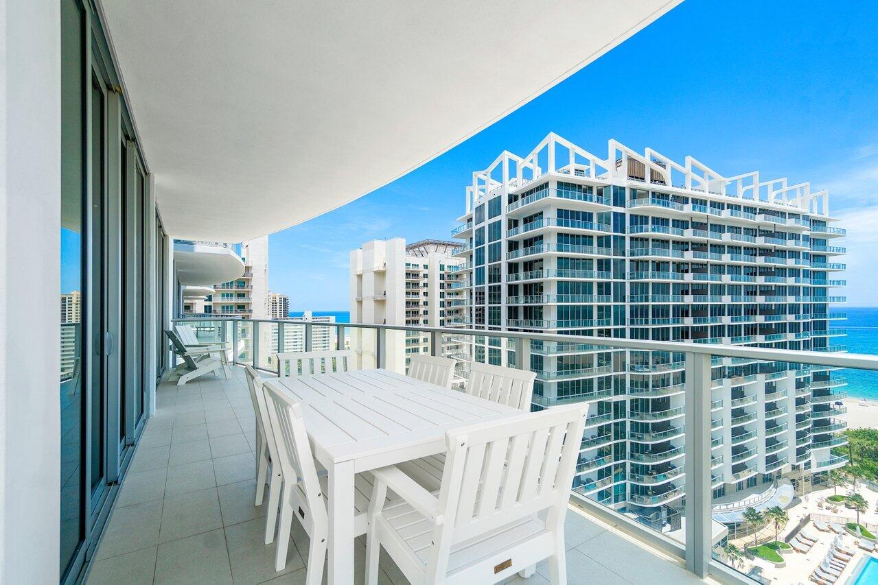 3100 North Ocean Drive, Unit 1505 Riviera Beach, FL 33404 - Photo 28 of 60 a view of a balcony with a dining table and chairs