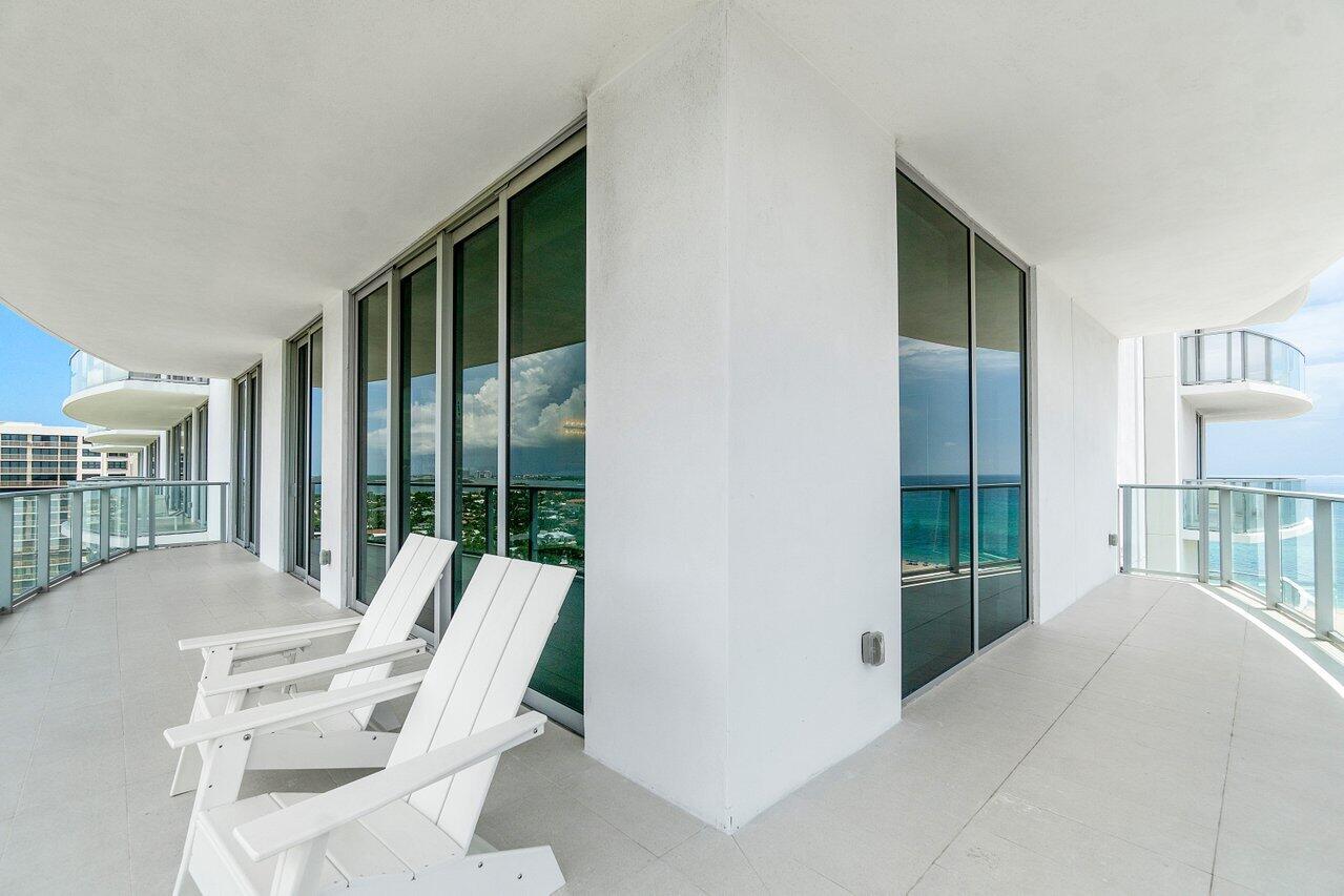 3100 North Ocean Drive, Unit 1505 Riviera Beach, FL 33404 - Photo 37 of 60 a balcony view with a large window and chairs
