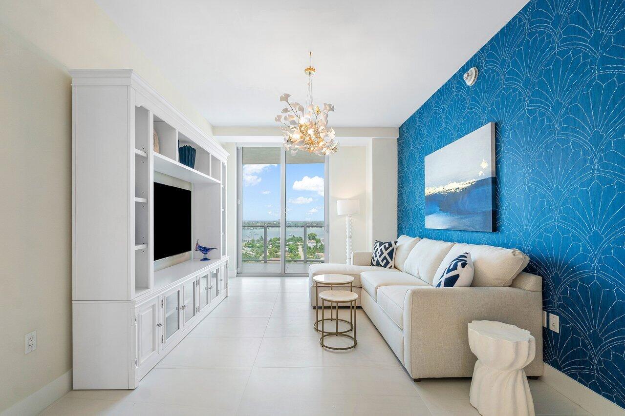 3100 North Ocean Drive, Unit 1505 Riviera Beach, FL 33404 - Photo 5 of 60 a living room with furniture and a flat screen tv