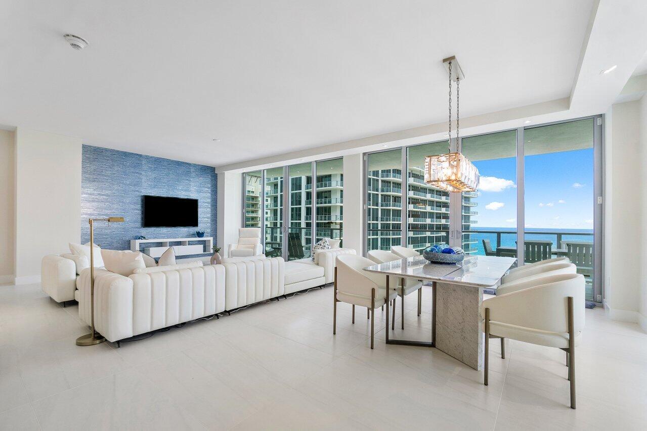3100 North Ocean Drive, Unit 1505 Riviera Beach, FL 33404 - Photo 10 of 60 a living room with furniture and a flat screen tv