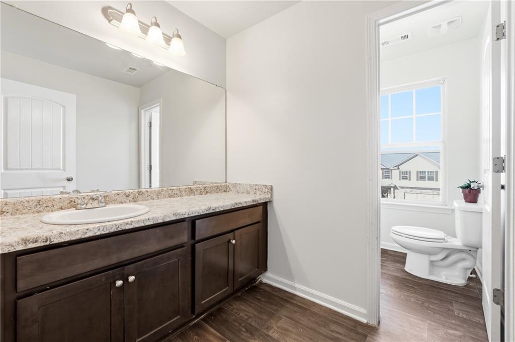677 Massey Street Winder, GA 30680 - Photo 24 of 30 a bathroom with a granite countertop toilet sink and mirror