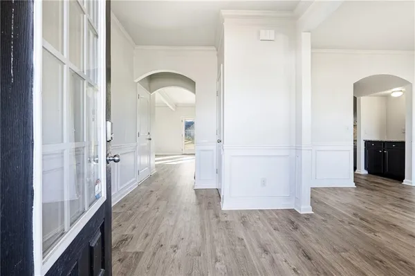 a view of a hallway with wooden floor
