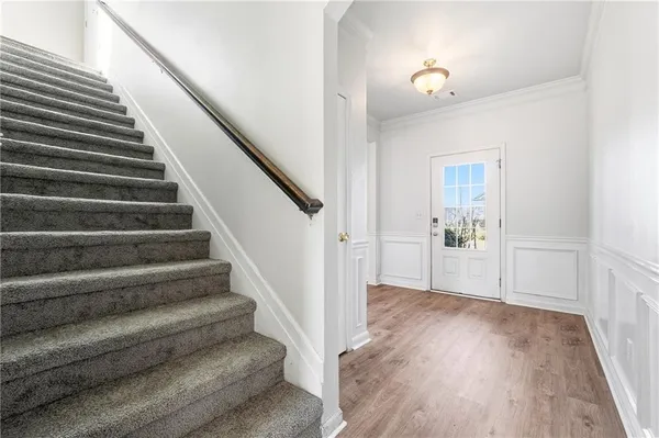 a view of entryway and hall with wooden floor