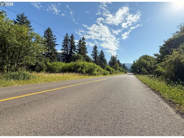 a view of a house with a yard and basketball court