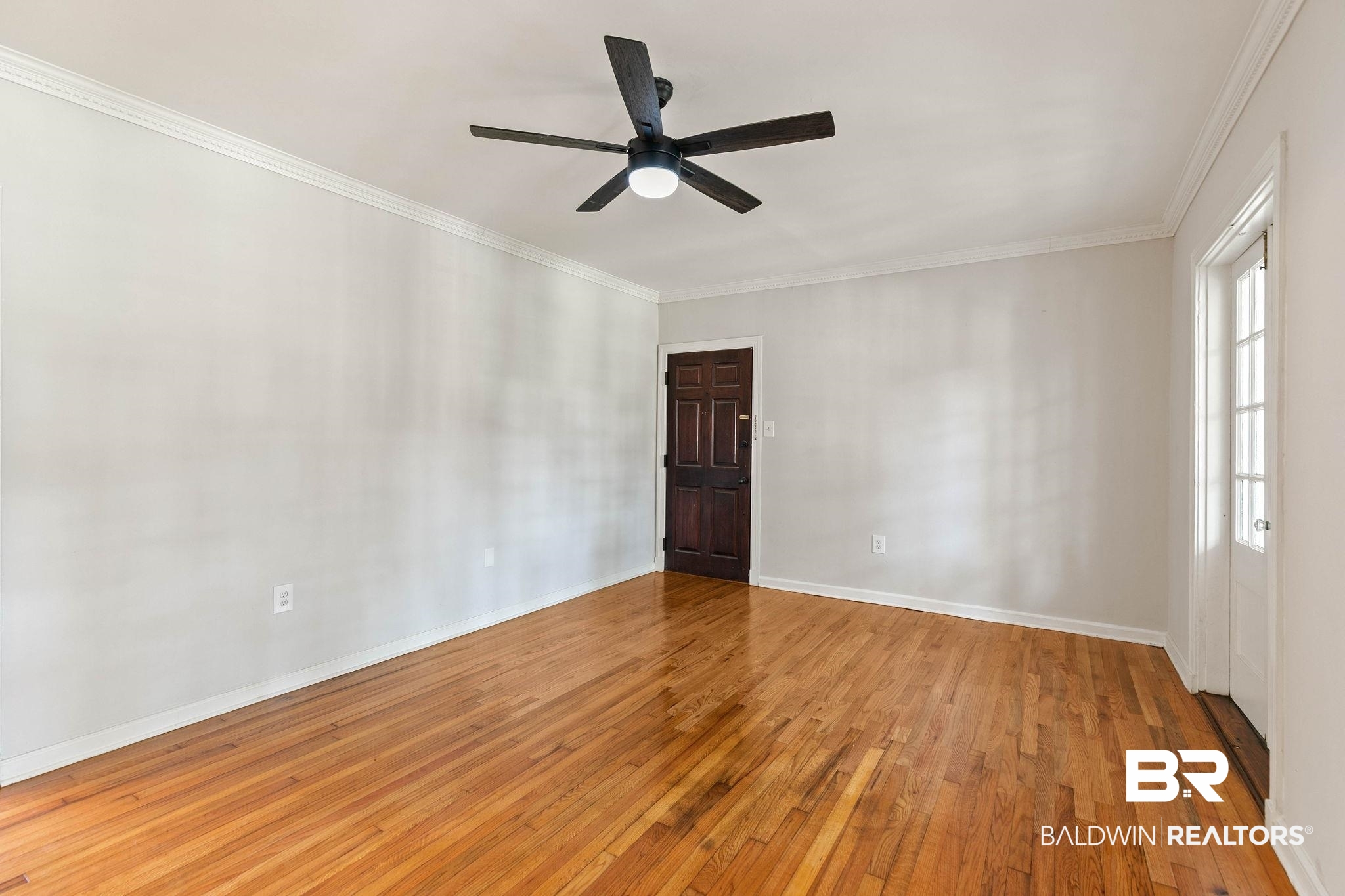 214 Upham Street, Unit 8D Mobile, AL 36607 - Photo 8 of 36 Spare room featuring light wood-type flooring, ceiling fan, and ornamental molding