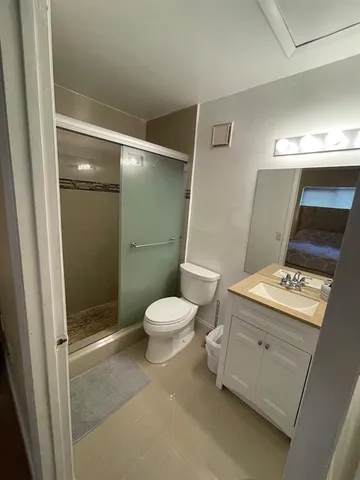 a bedroom with a bed and dresser with mirror