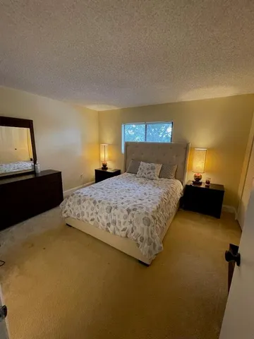 a bathroom with a sink mirror vanity and toilet