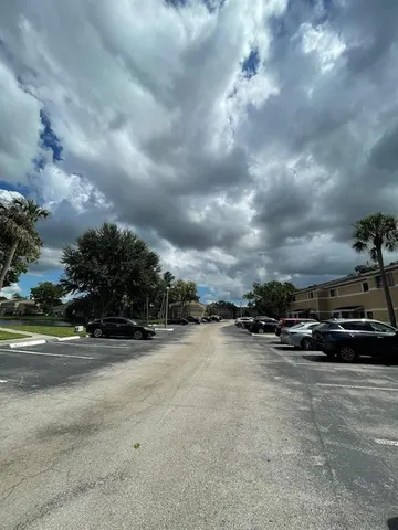 a view of car parked in parking lot of house and car parked