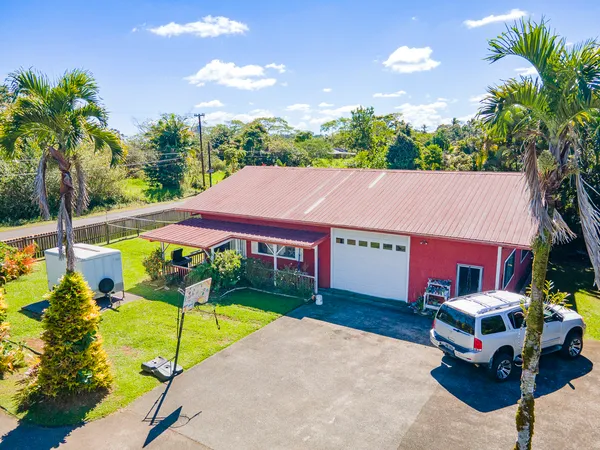 a aerial view of a house with swimming pool and garden