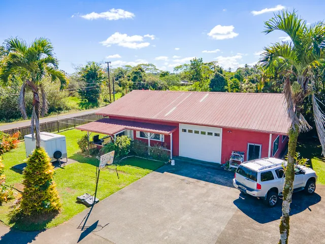 a aerial view of a house with swimming pool and garden