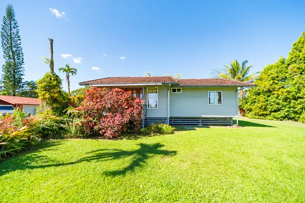 a front view of house with yard and green space