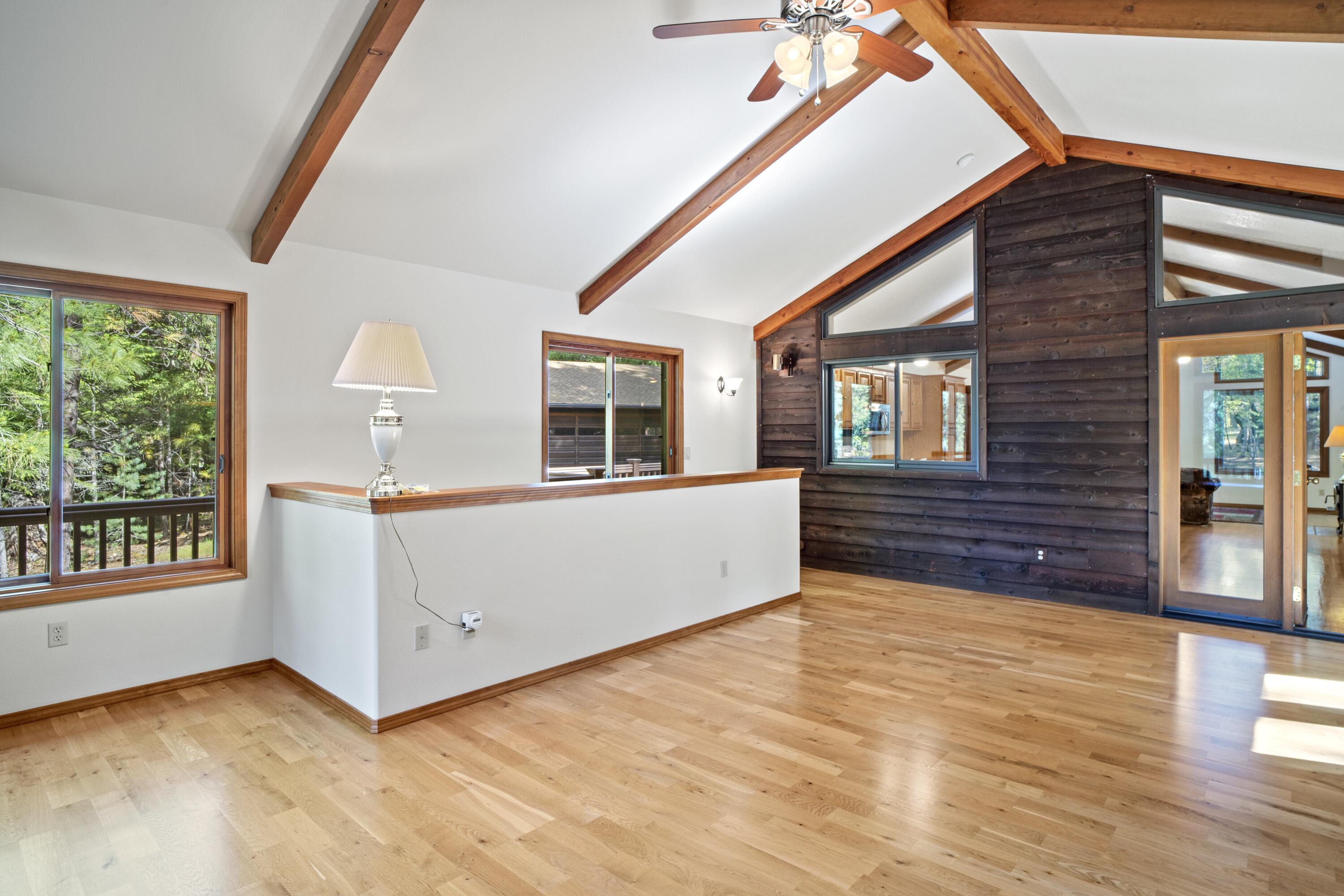 2021 Queens Branch Road Rogue River, OR 97537 - Photo 4 of 37 a view of an empty room with a window and wooden floor