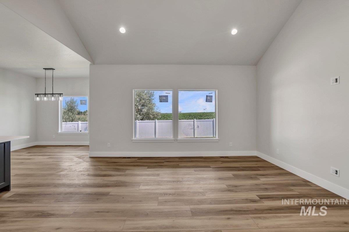 951 Gregory Way Twin Falls, ID 83301 - Photo 10 of 31 Spare room featuring vaulted ceiling, a chandelier, light wood-style flooring, and recessed lighting