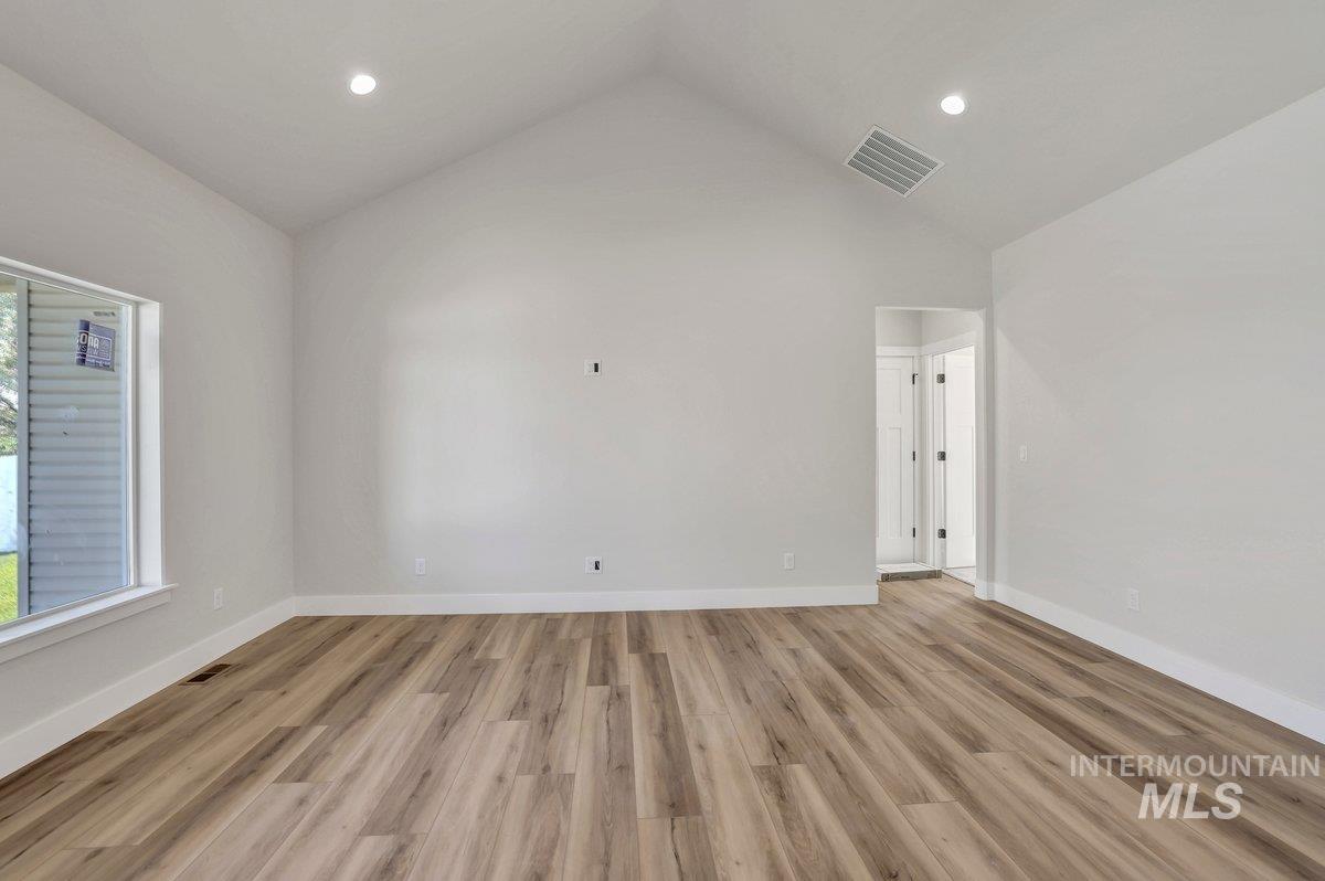 951 Gregory Way Twin Falls, ID 83301 - Photo 11 of 31 Empty room with light wood-type flooring, high vaulted ceiling, and recessed lighting