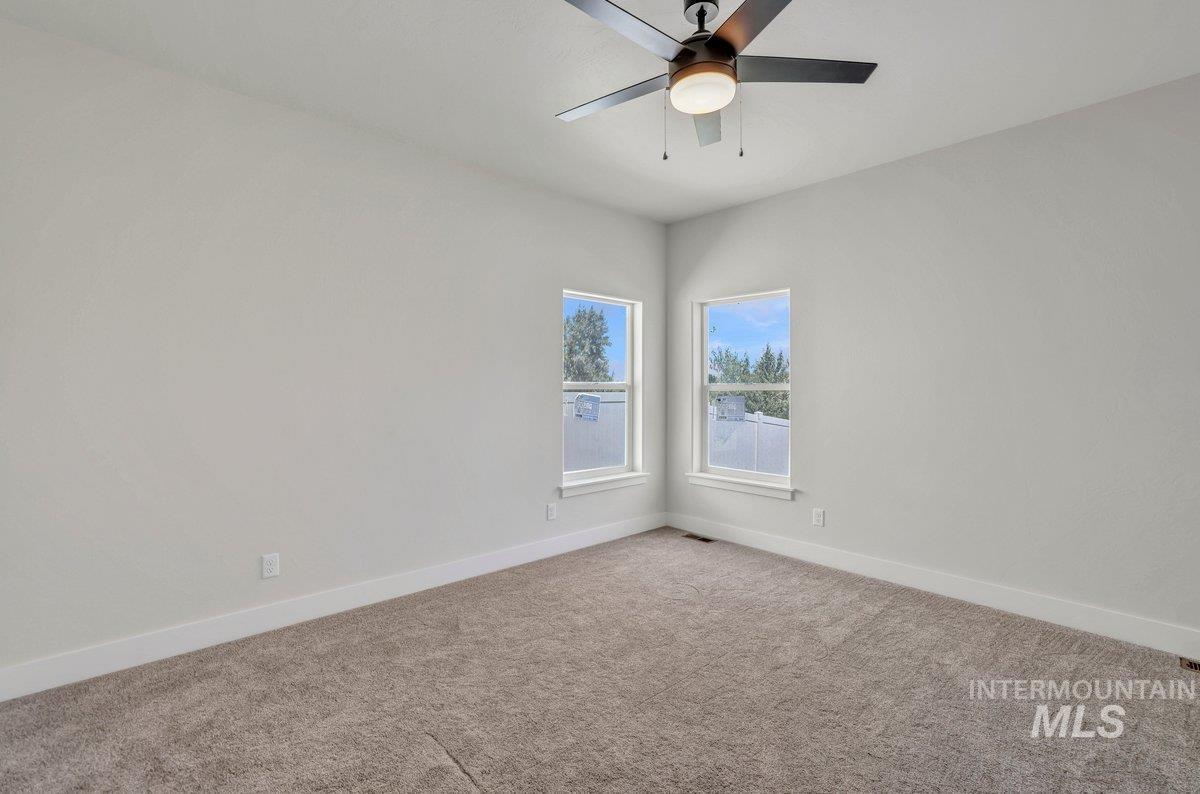 951 Gregory Way Twin Falls, ID 83301 - Photo 13 of 31 Carpeted spare room featuring baseboards and a ceiling fan