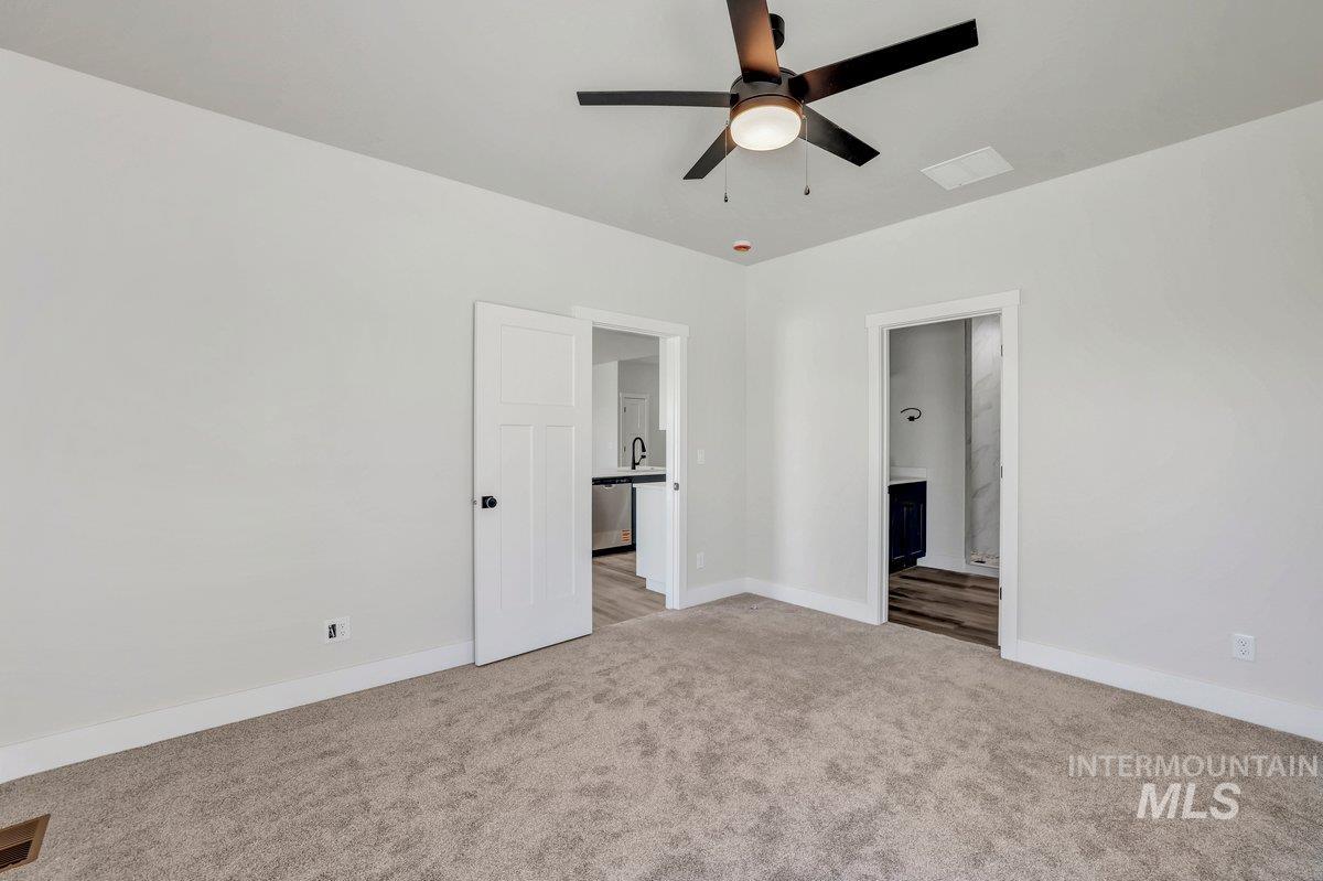 951 Gregory Way Twin Falls, ID 83301 - Photo 14 of 31 Unfurnished bedroom featuring light colored carpet and ensuite bath