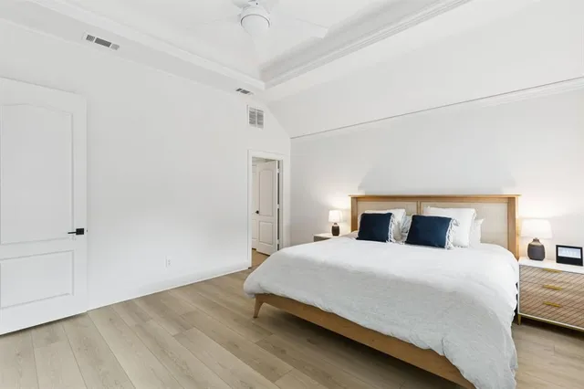 a bedroom with a bed and a night stand