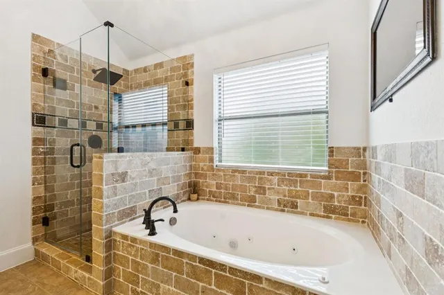 a bathroom with a bathtub and shower