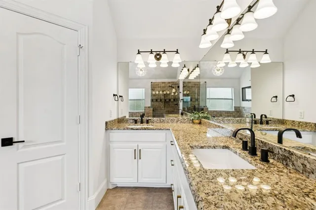 a large bathroom with a sink vanity granite and a mirror