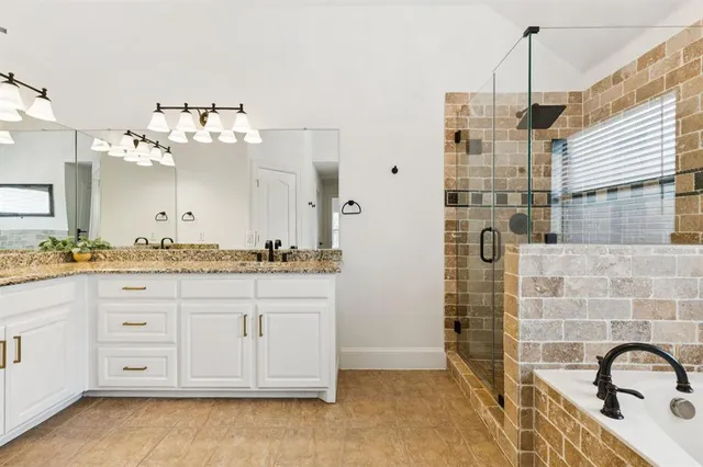 a bathroom with a double vanity sink a mirror and a shower