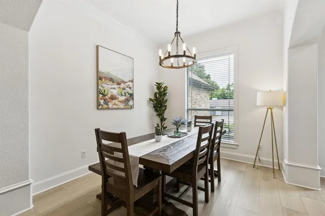 a view of a dining room with a table and chairs