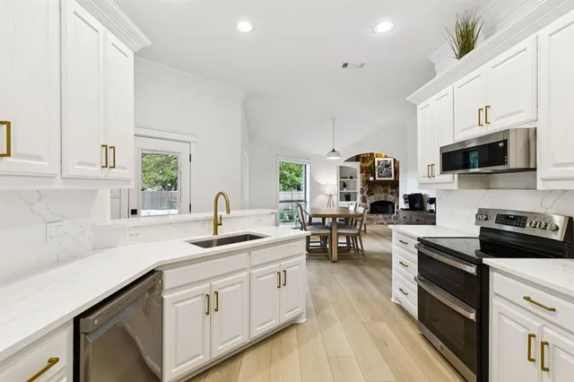 a kitchen with a sink stove and cabinets
