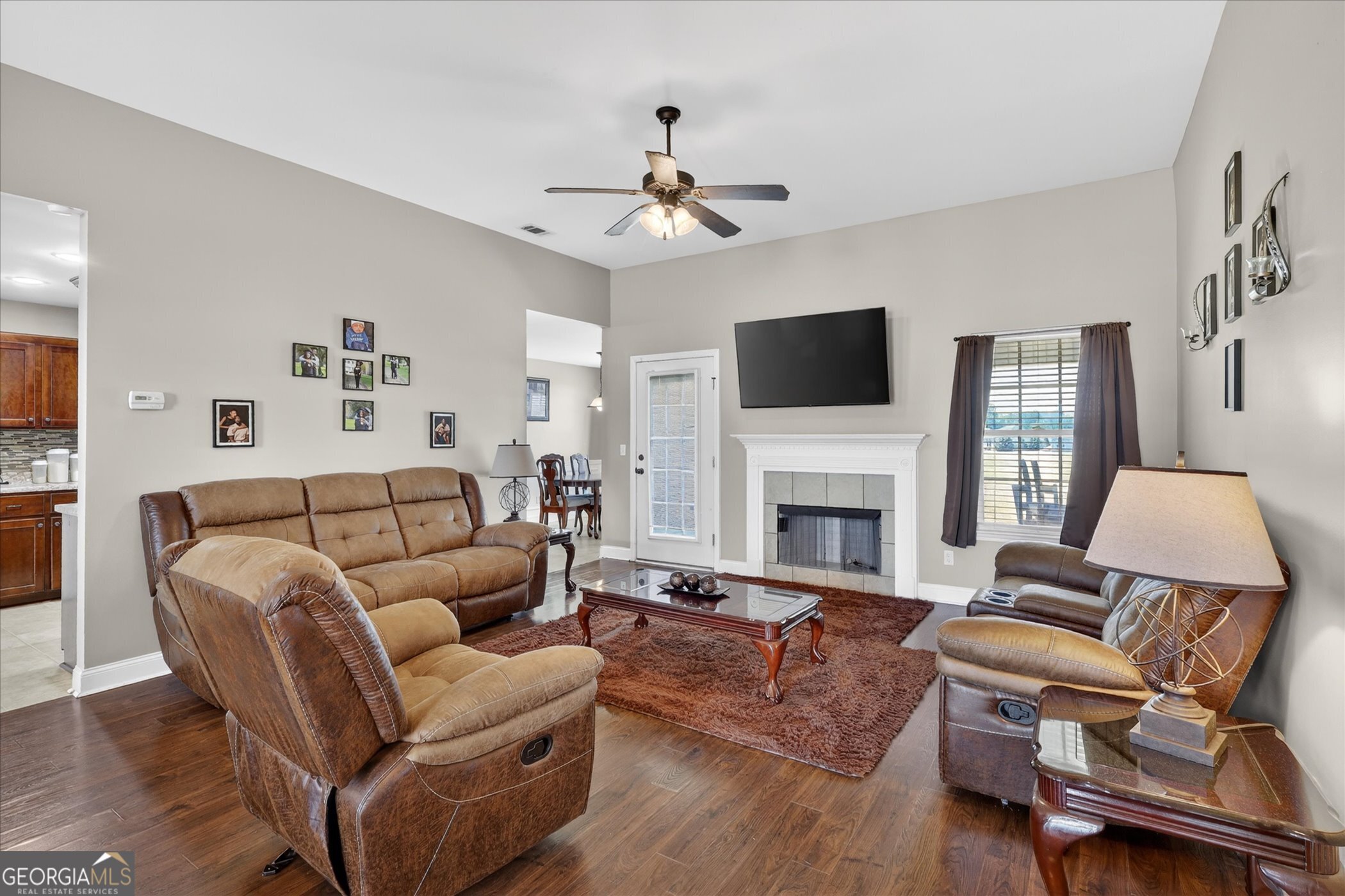 245 Stonebrook Way Statesboro, GA 30458 - Photo 11 of 32 a living room with furniture a fireplace and a flat screen tv