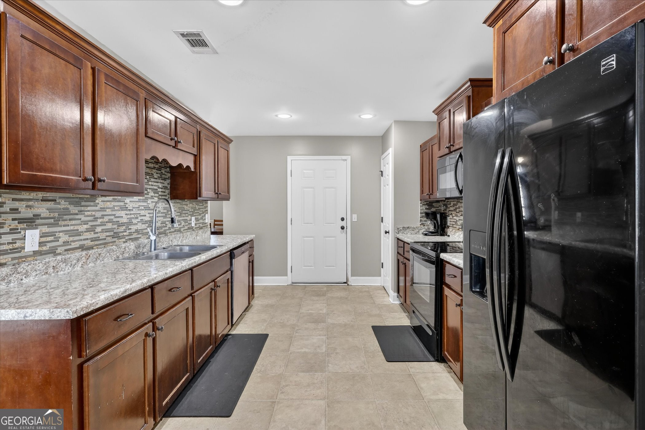 245 Stonebrook Way Statesboro, GA 30458 - Photo 14 of 32 a kitchen with stainless steel appliances granite countertop a sink stove and refrigerator