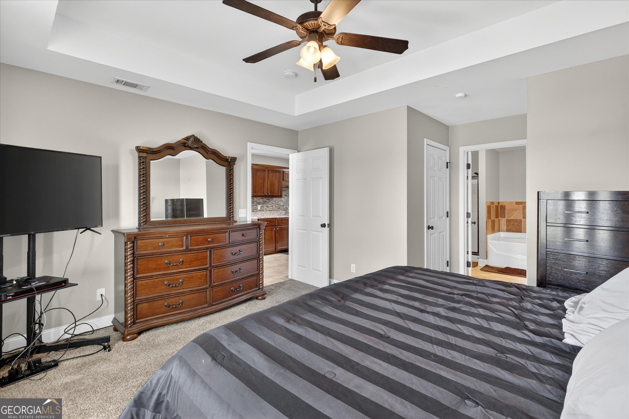 245 Stonebrook Way Statesboro, GA 30458 - Photo 16 of 32 a bedroom with a bed and a flat screen tv