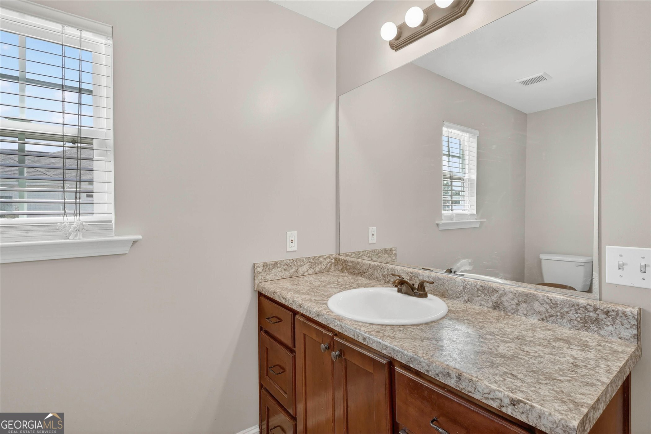 245 Stonebrook Way Statesboro, GA 30458 - Photo 19 of 32 a bathroom with a granite countertop sink and a mirror