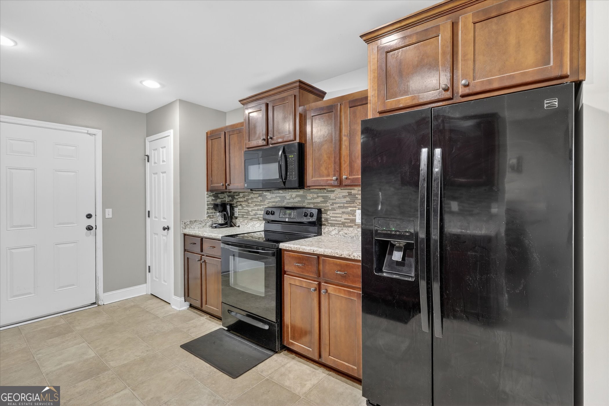 245 Stonebrook Way Statesboro, GA 30458 - Photo 20 of 32 a kitchen with stainless steel appliances granite countertop a refrigerator a stove and a sink with wooden floor
